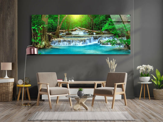 Waterfall In Tropical Forest glass wall art features a serene nature landscape and creates tranquility with a panoramic forest motif in a horizontal orientation