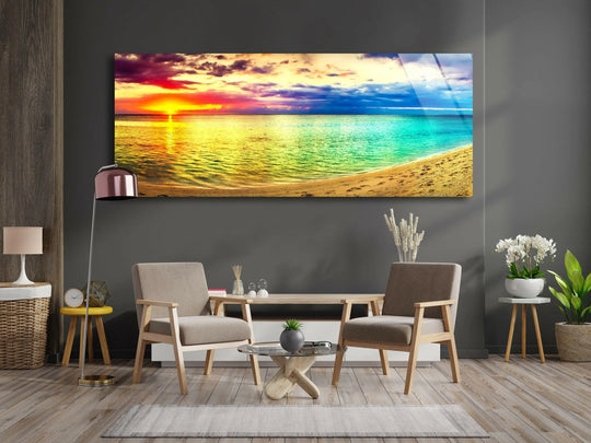 Colorful sunset and beach landscape glass wall art features a vibrant ocean and cloudy sky and complements modern wall decor in a living room