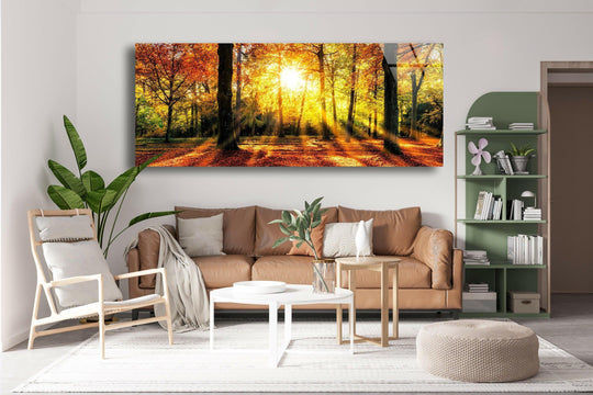 The landscape glass wall art shows an autumn forest scene with sunlight streaming through the trees and golden foliage and is landscape forest wall decor and fall wall art