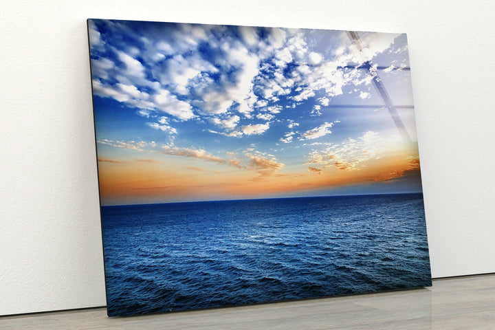 Tranquil ocean waves meet a colorful sky in this stunning glass wall art.
