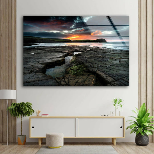 Vivid color saturation enhances the dramatic sunset over Kimmeridge Bay in this striking landscape glass wall art, making it a standout piece of home decor.