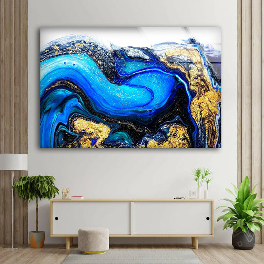 Horizontal and fluid abstract glass art painting featuring swirling sapphire blue and rich gold marbled patterns.