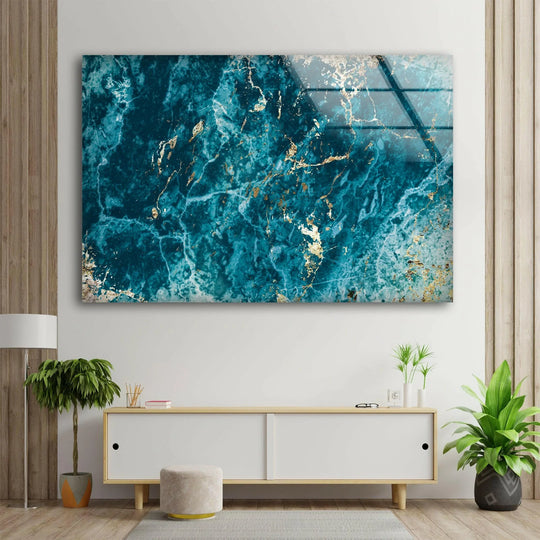 A richly saturated blue and turquoise marble glass wall art with streaks of shimmering gold, perfect for home decor.