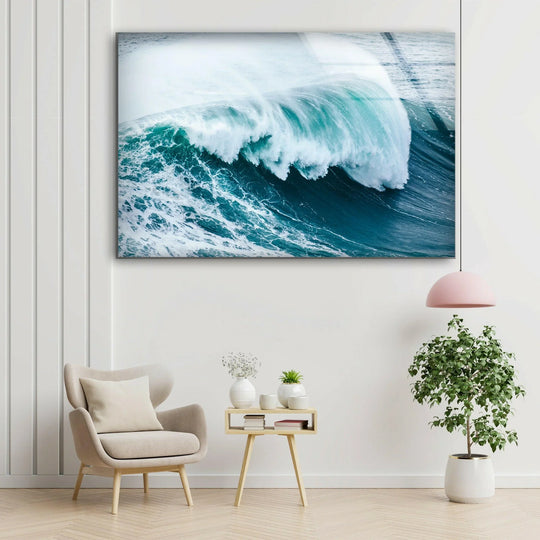 Ocean wave glass wall art showcases a dynamic seascape and coastal decor and is a landscape in ocean blue tones and tempered glass for modern walls on a white wall