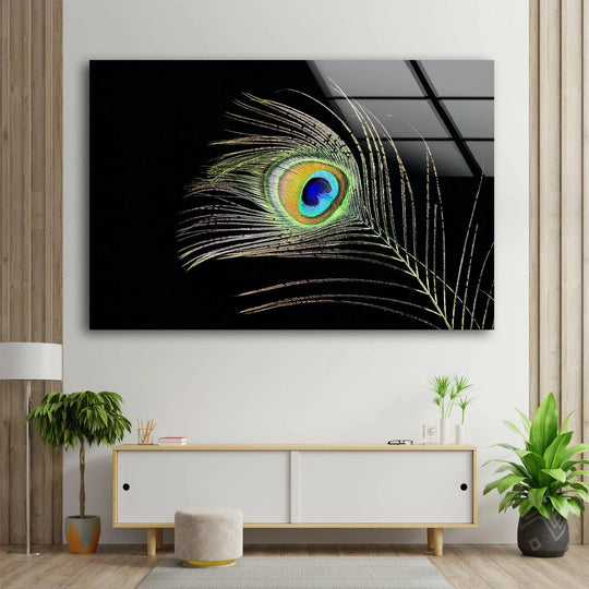 A glass wall art of a peacock feather showcases its iridescent texture on a black background.