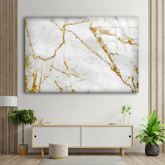 A striking white marble with gold details glass wall art decor is the loudest element in this minimalist living room.