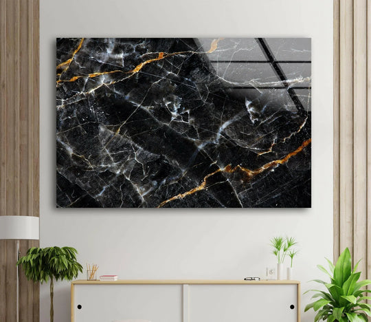 This abstract hanging wall art features a glossy, reflective black marble finish with intricate gold and white veining.