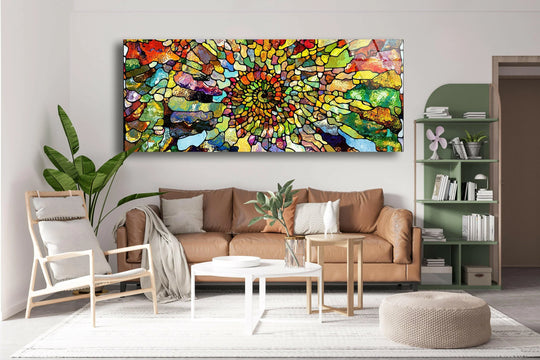 Colorful abstract stained glass wall art features a vibrant floral motif and mosaic design above a tan sofa in a living room