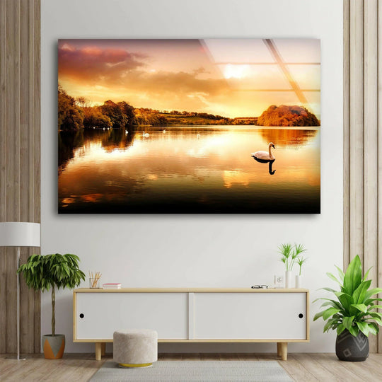 The darkest area of the golden sunset lake is mirrored in the water on this glass wall art, offering a tranquil home decoration.