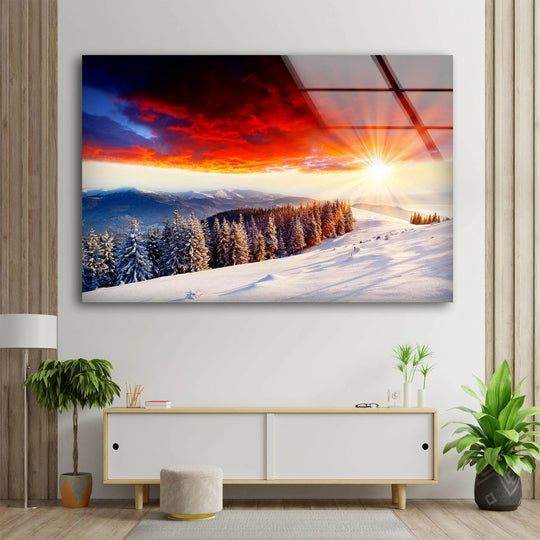 Evoking a serene mood, this snowy mountain sunset glass wall artwork captures the awe-inspiring beauty of a winter wonderland through the golden light on snow.
