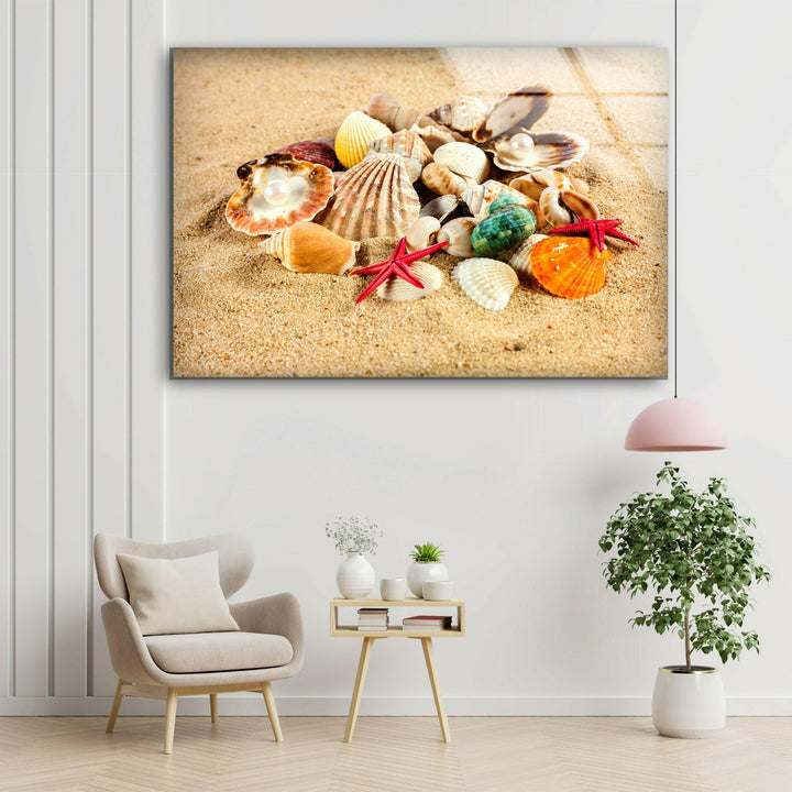 Close-up of starfish and seashells on a textured sandy surface, capturing coastal beauty.
