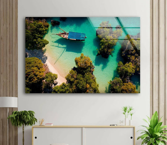 Captivating shapes and colors create an abstract hanging wall art vision in this 'Tropical Lagoon Aerial View' glass wall art, blending textures of water and island foliage.