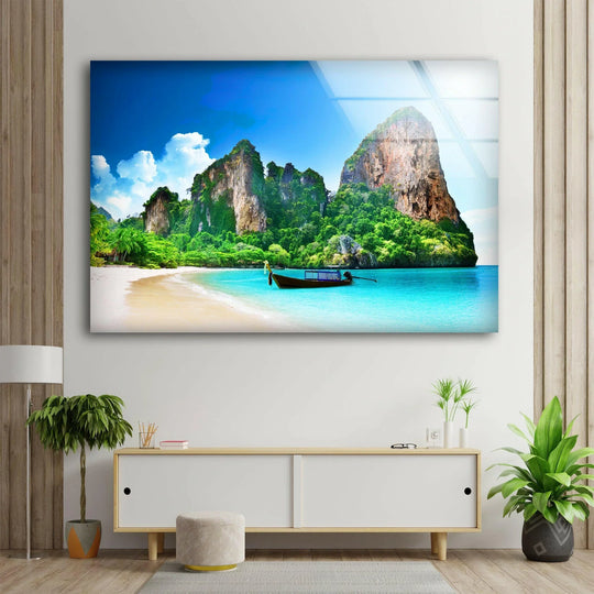 Highlighting the focal point, the Phuket tropical island glass wall art showcases a serene beach and dramatic rock formations with vivid glass printing.