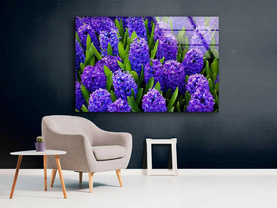A soft bed of vibrant purple hyacinth flowers creates a beautiful scene for this glass wall art.