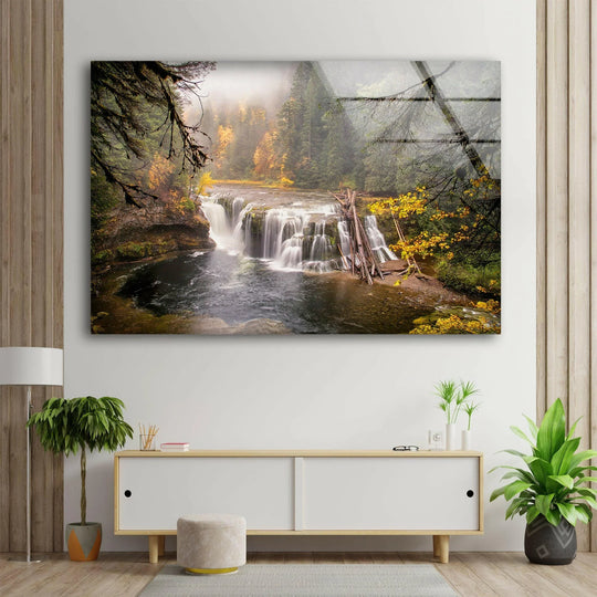 Enhanced color saturation highlights the vibrant autumn foliage and cascading waterfall in this stunning glass wall art print, a captivating home decoration.