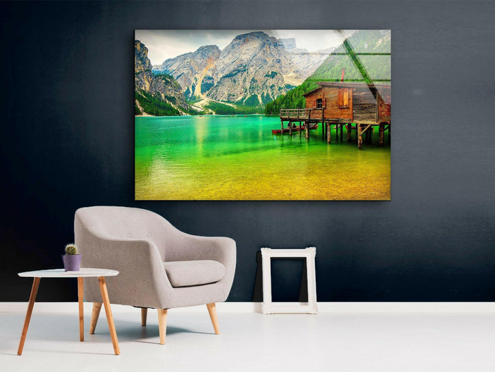Stunning large landscape wall art of a mountain lake with a wooden dock and cabin.
