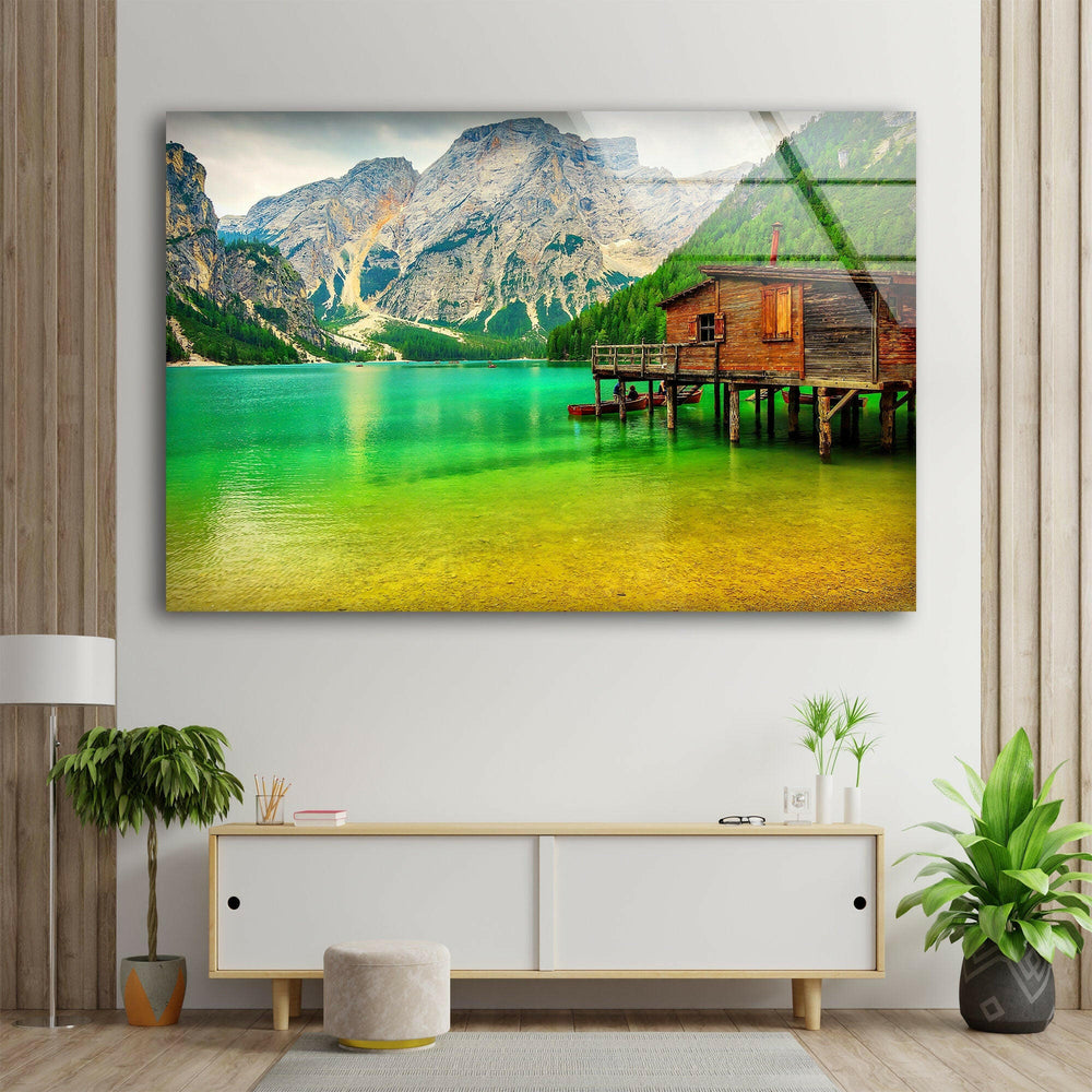 Serene landscape wall art of a crystal-clear green lake reflecting towering mountains.

