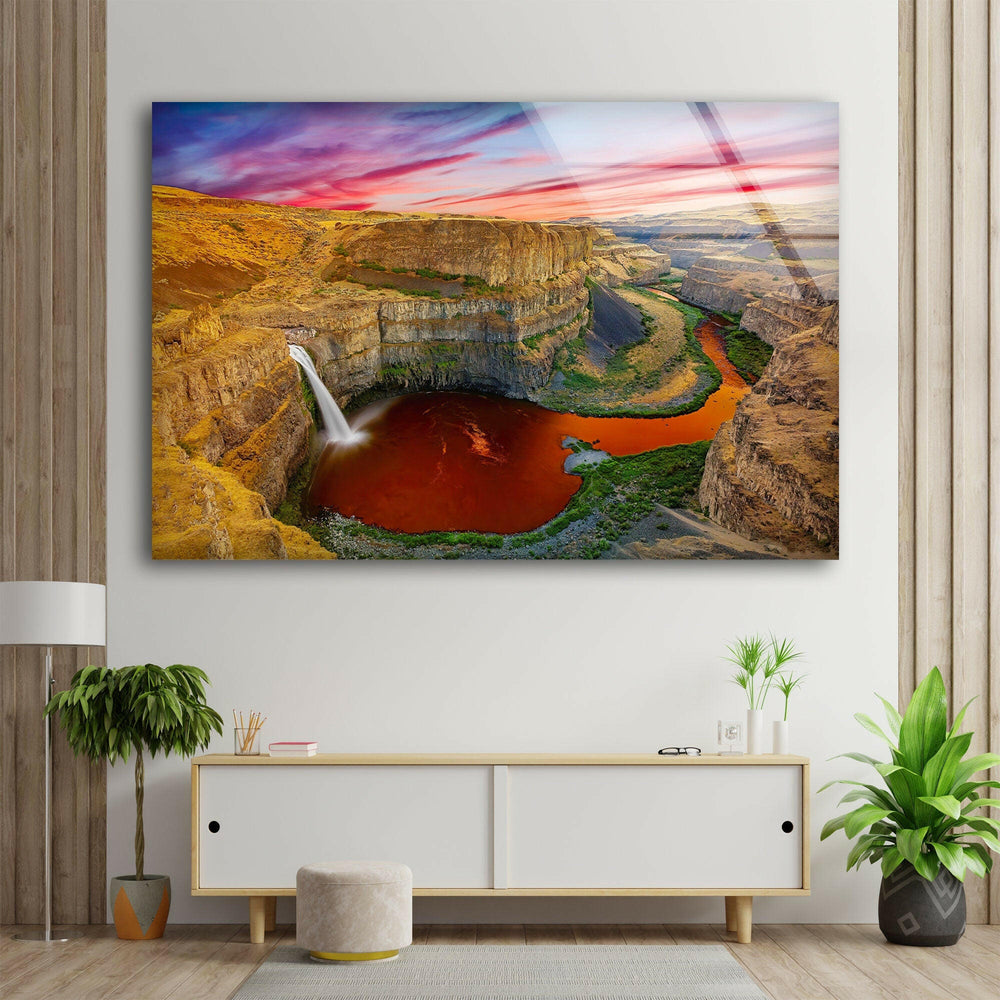 Stunning landscape featuring a cascading waterfall and dramatic rock formations.
