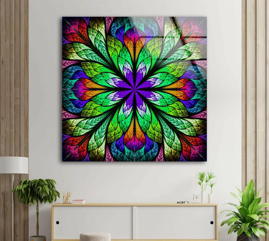The brightest area of this fractal flower glass art features vibrant green and purple hues radiating from the center.