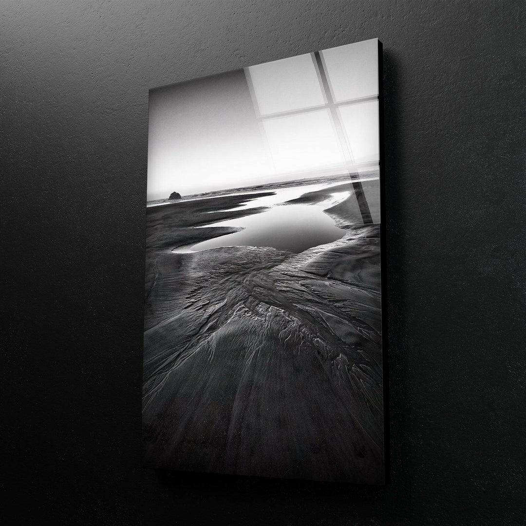 A striking seaside view on tempered glass, with dramatic black and white tones highlighting the beauty of the beach.
