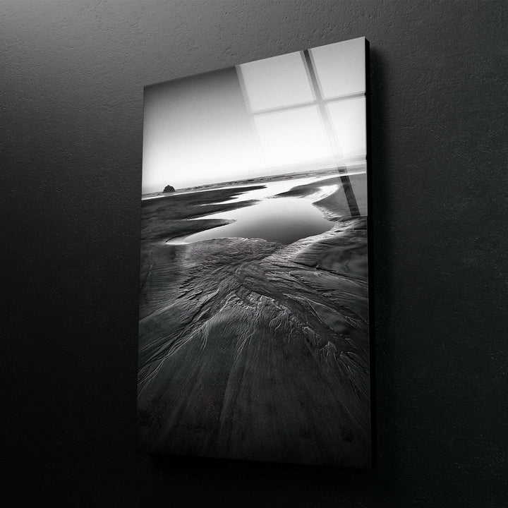 A striking seaside view on tempered glass, with dramatic black and white tones highlighting the beauty of the beach.
