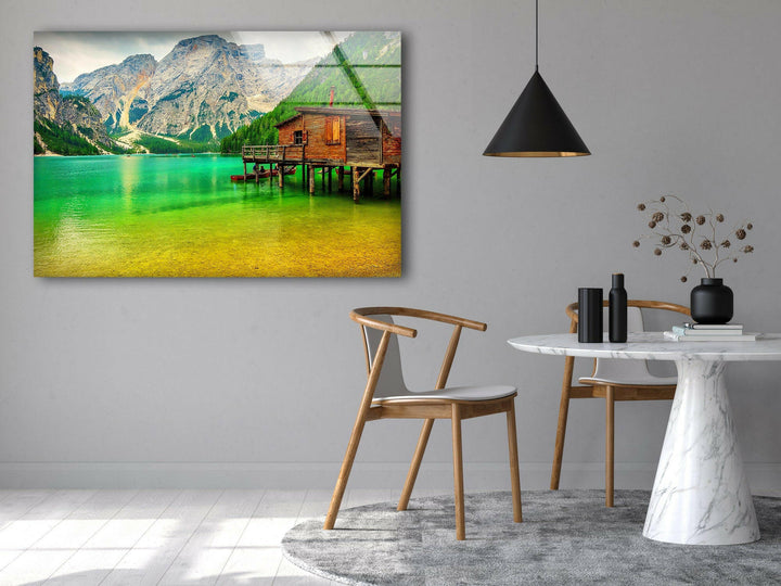 A stunning landscape photo for sale showcasing a cozy lakeside cabin amid mountains.
