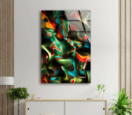 A glossy glass art panel displays a complex, rippling surface texture with swirling patterns of deep green, vibrant orange, and bright teal.