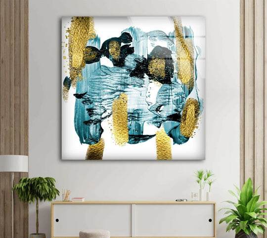 Abstract glass wall art showcasing a vibrant transition of teal to gold brushstrokes with black accents.