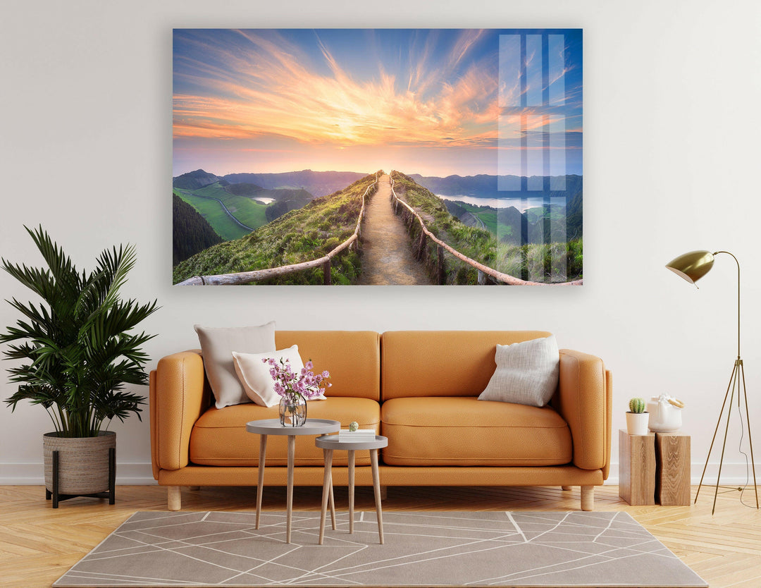 Nature-inspired glass wall art featuring a vibrant sunrise over lush green valleys.
