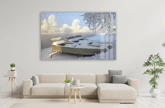 Foregrounding the snow-covered, rustic wooden boat, this glass wall art, 'Frosty Winter Serenity,' brings serene home decor to any space.