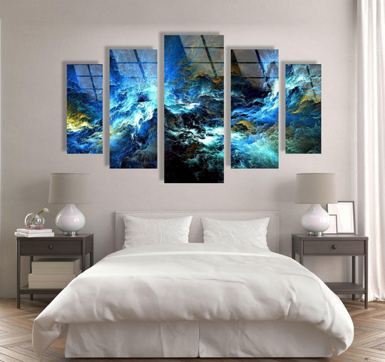 Five-piece cosmic blue storm abstract hanging wall art features a mesmerizing blend of swirling blues and golds as the focal point of a bedroom.
