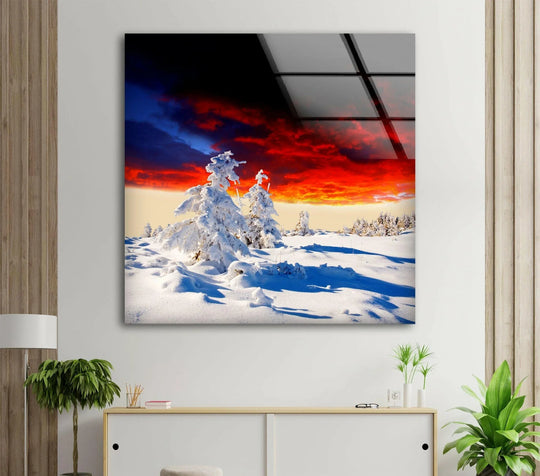 Foreground snowdrifts highlight the stunning snowy sunset landscape with vibrant colors in this breathtaking winter scene glass printing.