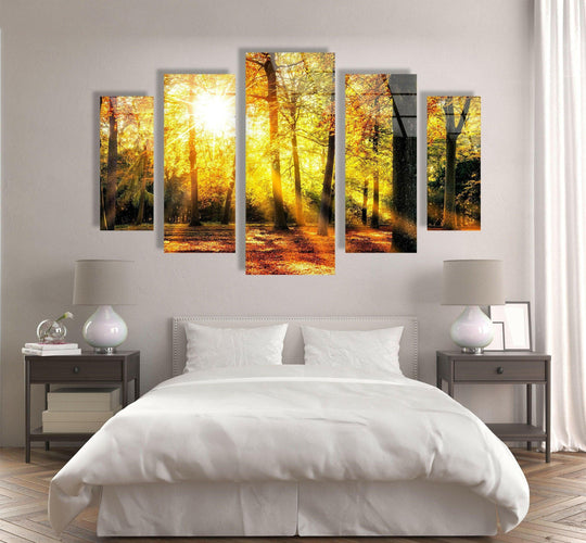 The forest glass wall art shows sun rays and autumn leaves in a vivid nature print and is a beautiful forest wall art home decor selection