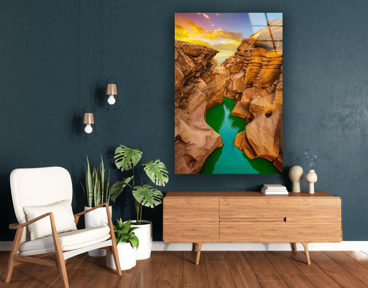 Serene canyon view with warm golden tones and crystal-clear river reflections.
