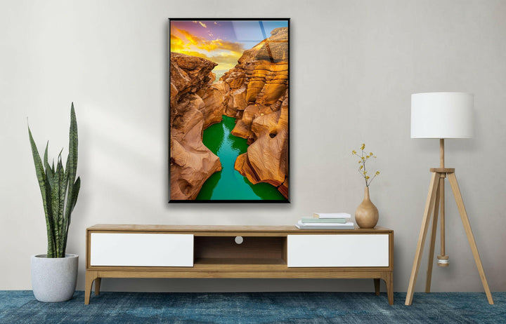 Nature-inspired artwork featuring a rugged canyon illuminated by a glowing sunset.
