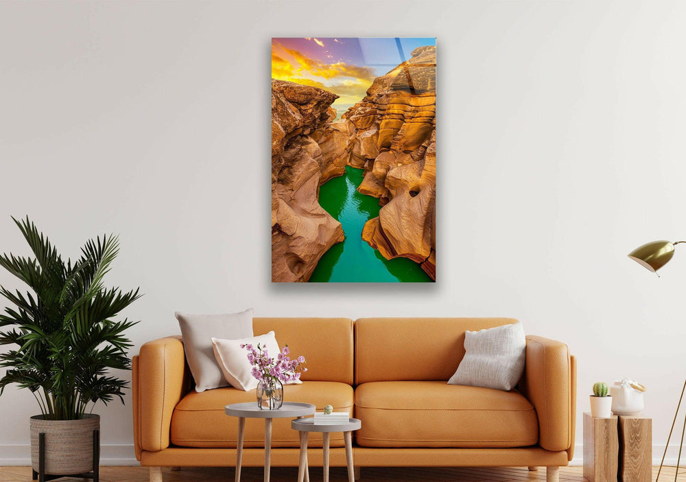 Stunning canyon sunset reflecting in turquoise waters, creating a mesmerizing natural scene.
