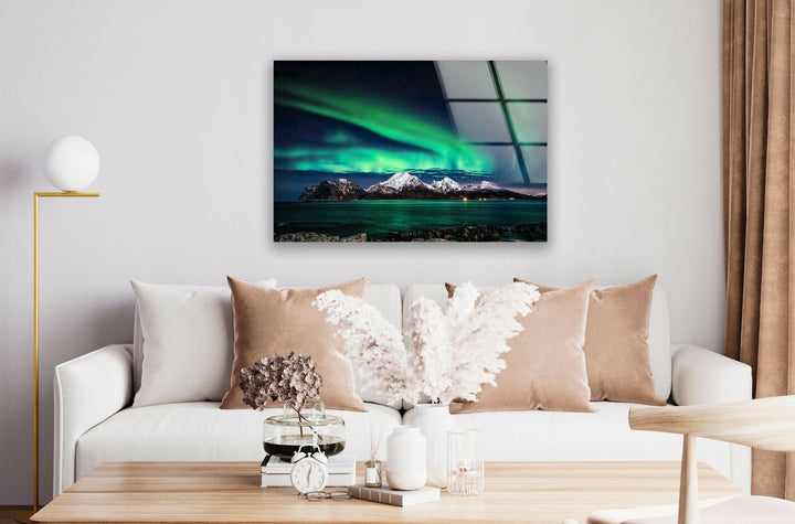 Stunning panoramic view of an Arctic landscape illuminated by the aurora borealis.
