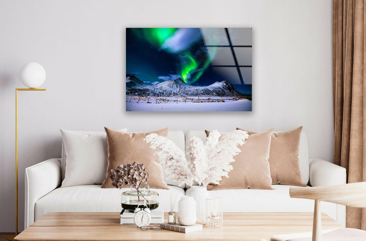 Vibrant green Northern Lights dancing over snow-covered mountains, captured in high definition.
