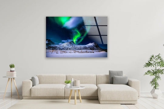 Deep color saturation enhances this glass printing landscape art print of the northern lights illuminating snowy peaks with vibrant green and blue hues.