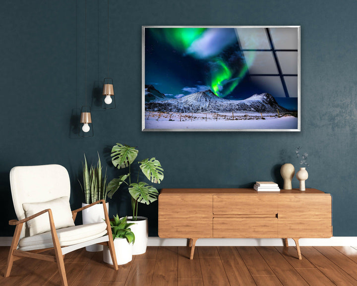 Starry Arctic sky with swirling green Northern Lights and crisp mountain reflections.
