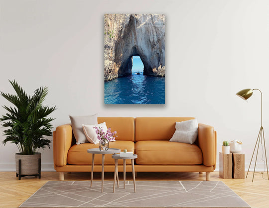 Showcasing pristine clarity, the coastal rock archway glass wall artwork highlights the vivid details of azure waters and textured stone.