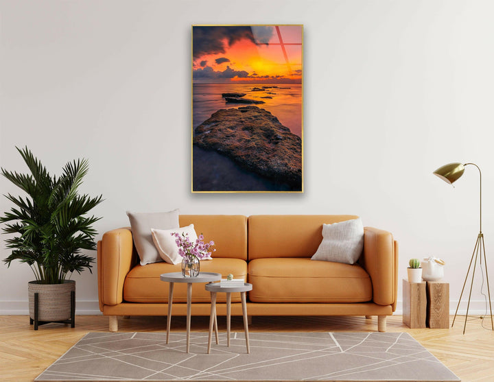 Breathtaking ocean sunset with vibrant orange and purple hues reflecting on the water.
