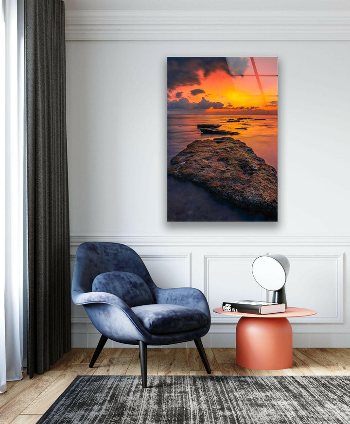 Stunning panoramic view of a sunset-lit shoreline with reflections on the ocean.
