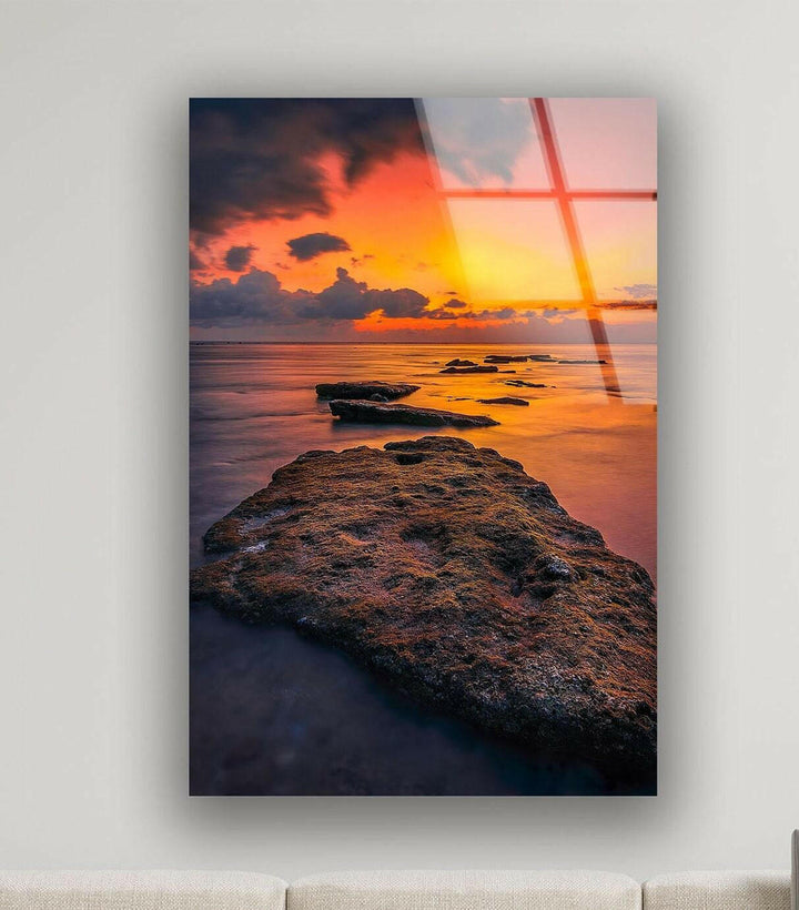 Serene coastal landscape featuring a rugged shoreline and warm sunset glow.
