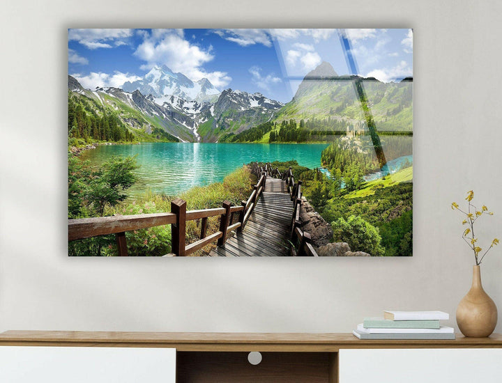 High-definition glass wall art showcasing a serene mountain lake with lush greenery.
