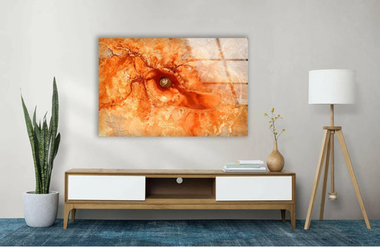 Orange marbled glass wall art features a soft, glowing central orb within its abstract design.