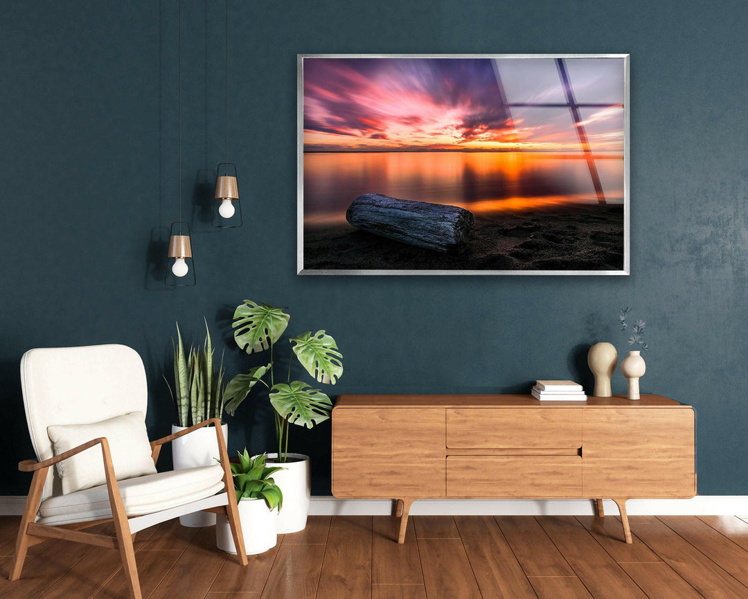 A dreamy sunset scene with soft waves lapping against a sandy shore.
