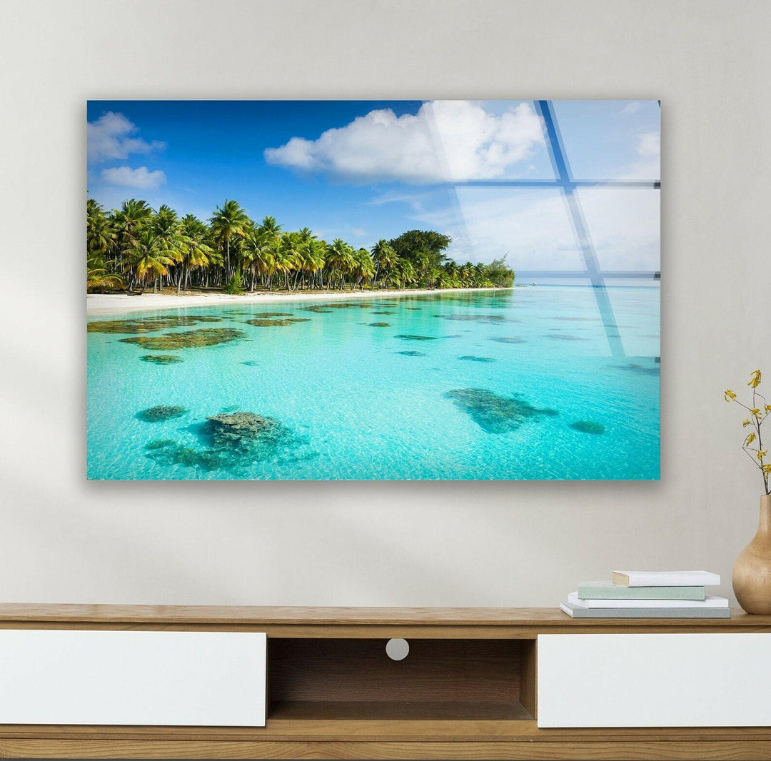 High-definition glass wall art showcasing a serene tropical landscape with blue waters.
