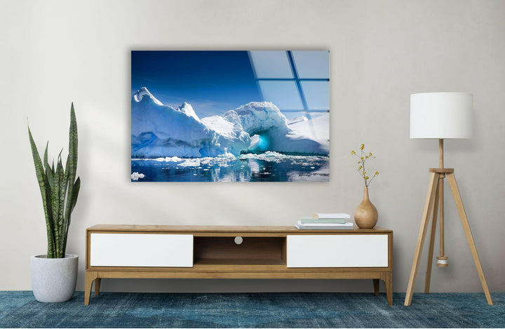 High-definition glass wall art showcasing a peaceful iceberg under a bright blue sky.
