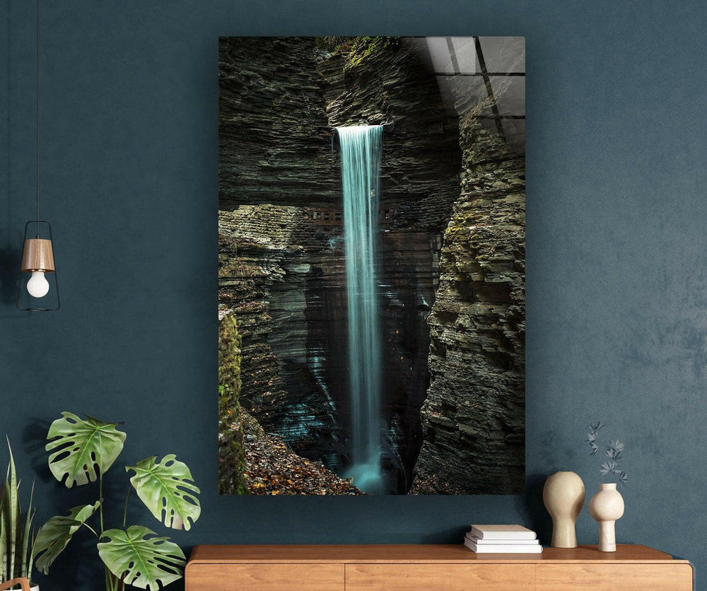 Mystical waterfall flowing through a dramatic canyon, creating a serene and captivating nature scene.
